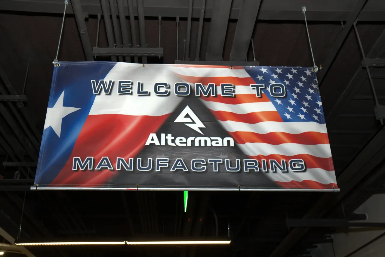 Alterman Manufacturing banner at an indoor company event.