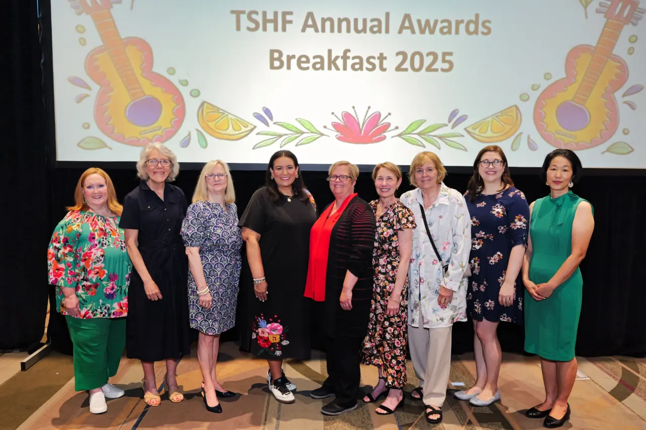 Women honorees pose beneath the TSFH Annual Awards Breakfast 2025 sign.