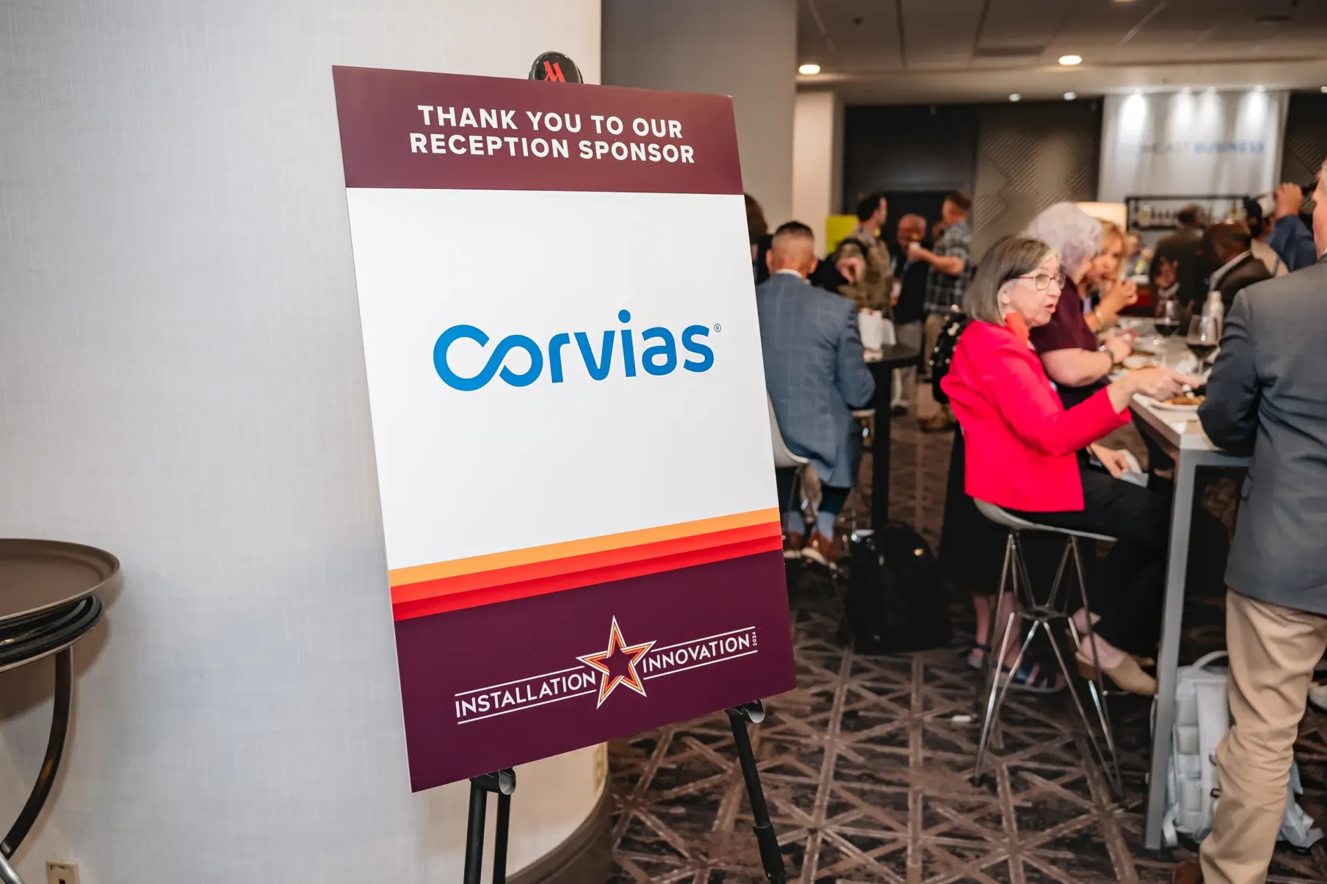 Corvias sponsor display at an event reception.