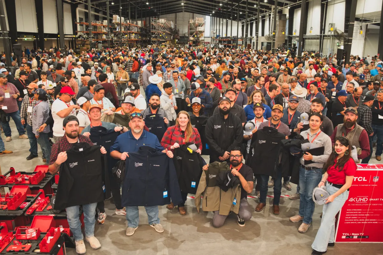 A large group poses together at a company event.