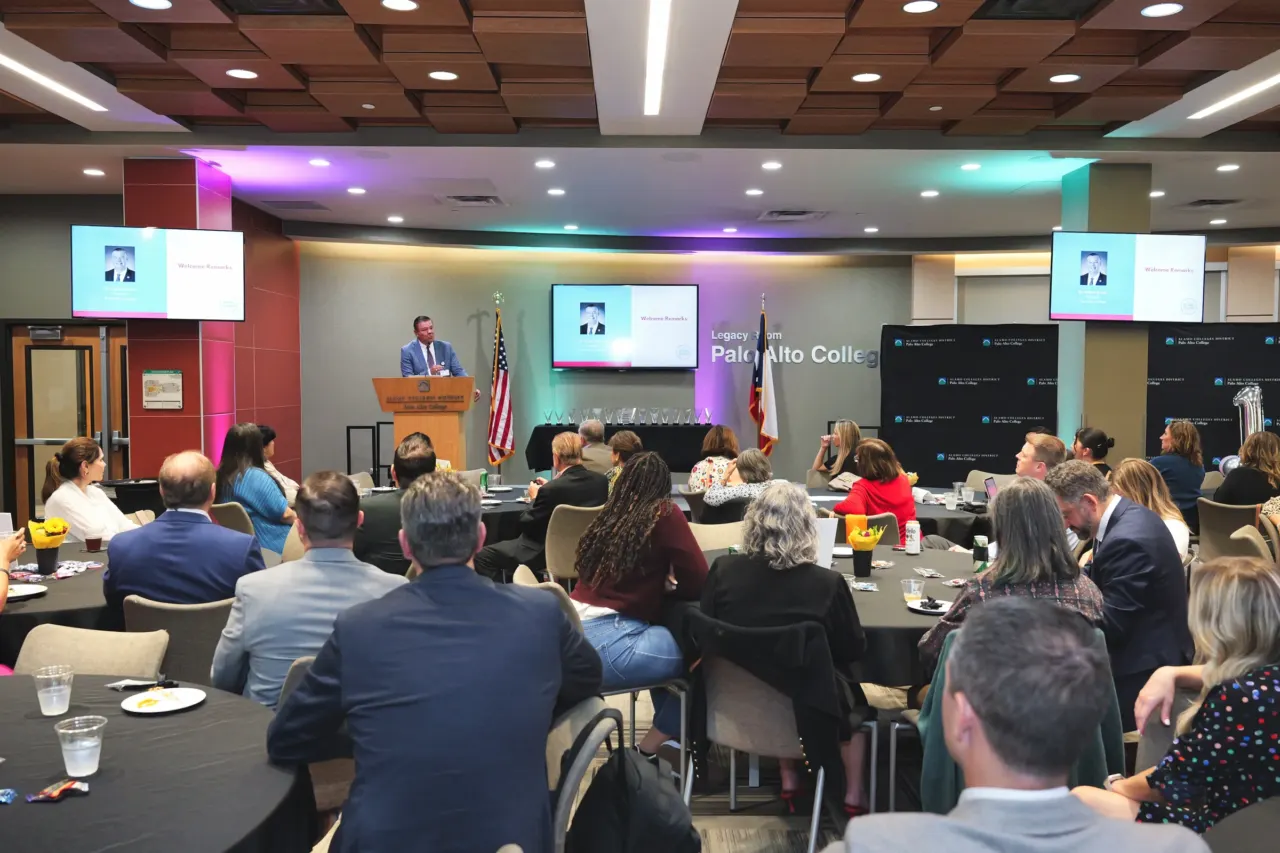 A speaker addresses attendees at a corporate event.