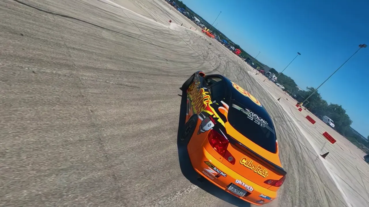 Aerial view of a race car on a broad marked driving course.