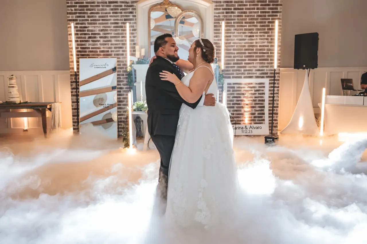 Newlyweds share a first dance above low fog.